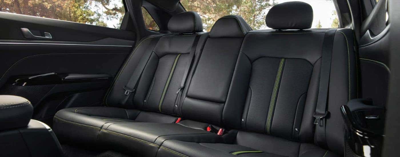 Rear black seats with green stitching on a 2026 Kia K5.