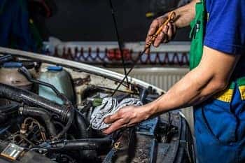Checking the Synthetic Motor Oil with Dipstick
