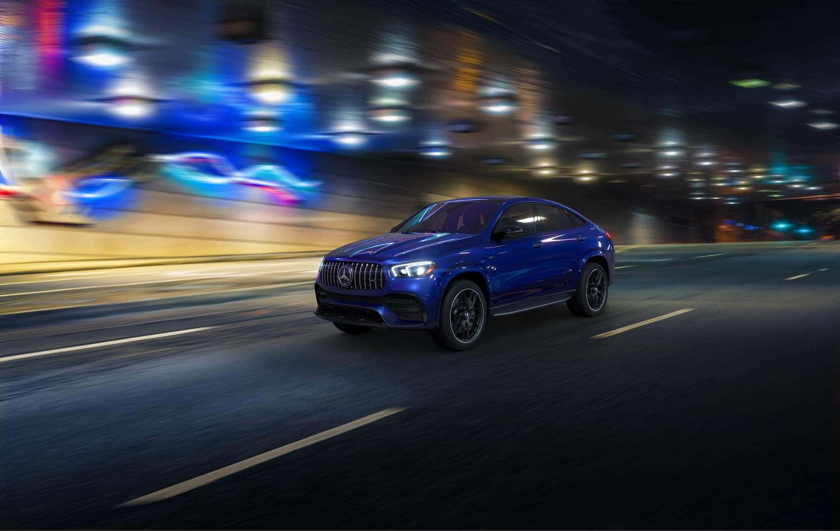 2022 Mercedes-Benz GLE driving by neon lights at night
