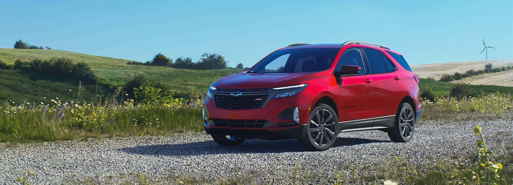2023-Red-Chevrolet-Equinox-parked-on-a-gravel-road-in-a-field_mobile