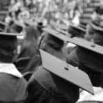 A group of students at a graduation ceremony in black and white