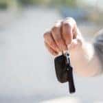 A man holding car keys
