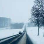 Car driving in snowy weather
