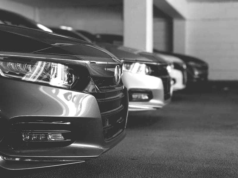 Grayscale Photo of Cars at a Dealership in Bedford, OH