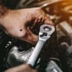 Technician working on Chevy engine
