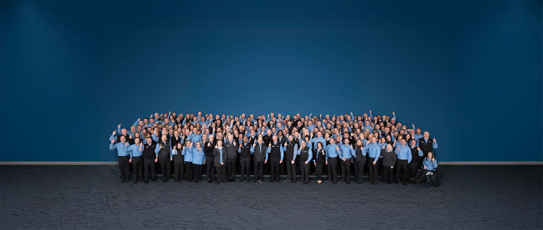Hendrick employees standing in front of Hendrick HQ
