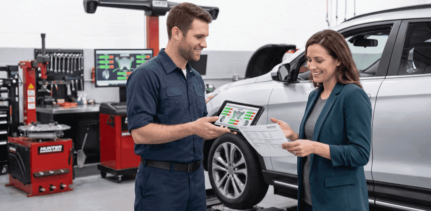 Service advisor going over tire alignment results with a customer at Singing River CDJR