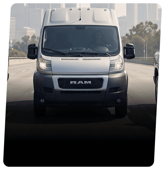 Silver RAM ProMaster cargo van driving on a highway