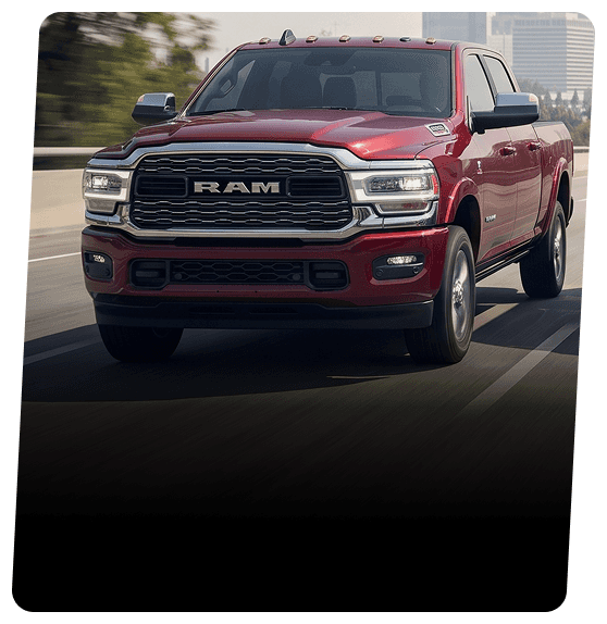 Red RAM pickup truck driving on a city highway