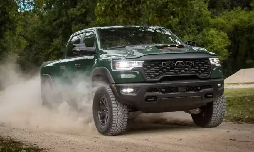 Green 2027 RAM 1500 driving off-road through dust