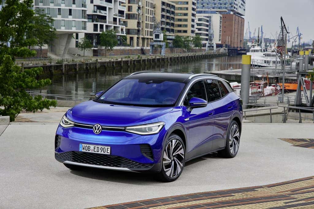BLue electric Volkswagen ID.4 SUV Outside Buildings Boats