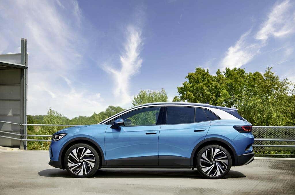 Blue Volkswagen ID.4 EV SUV Sky Green Trees Building