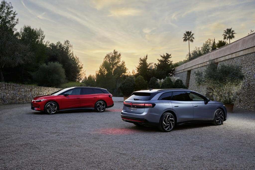 Red and Silver Volkswagen ID.3 GTX and ID.7 GTX Wagons Trees Building