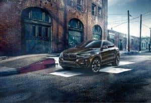 BMW parked by sidewalk