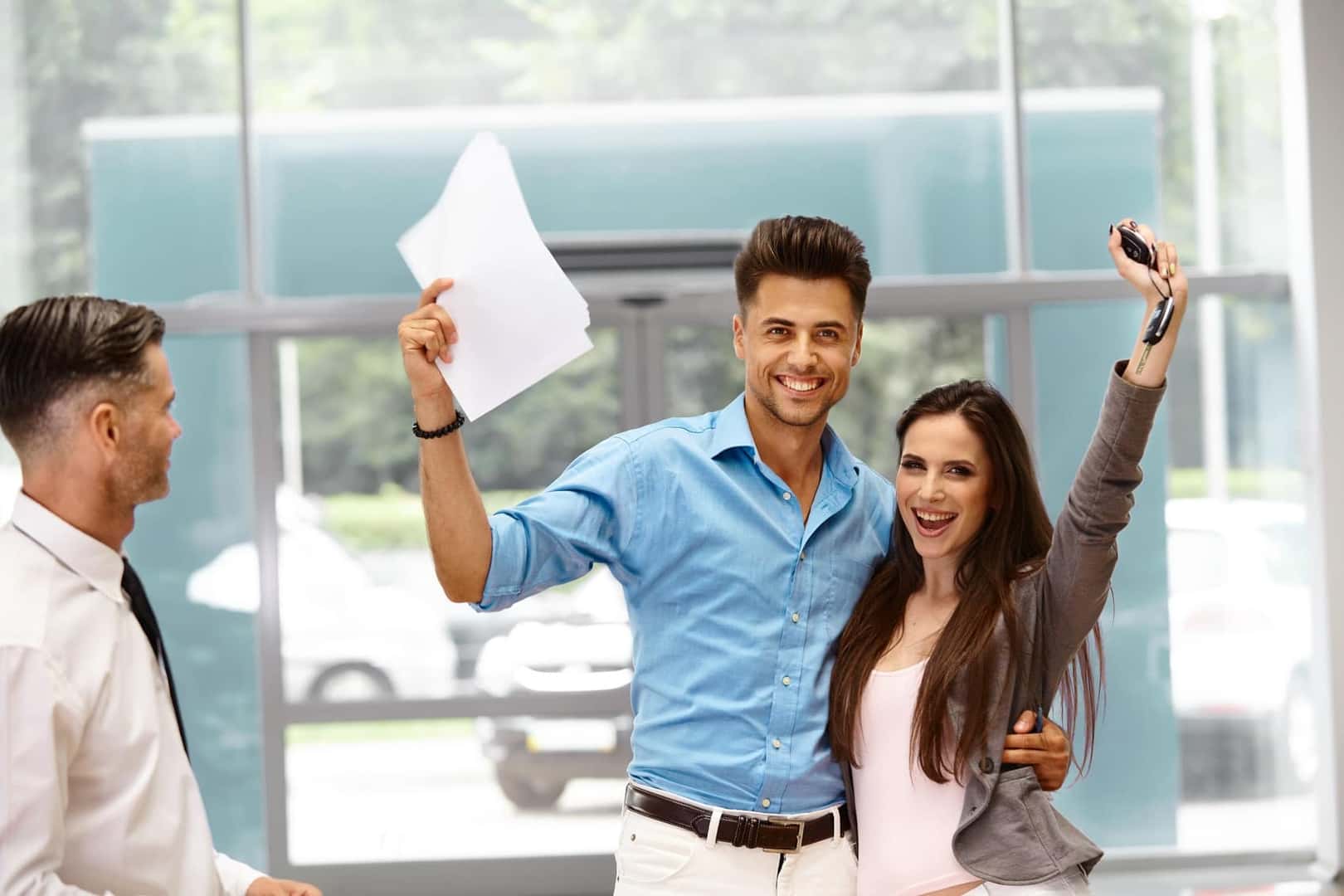 Happy couple celebrating buying a BMW