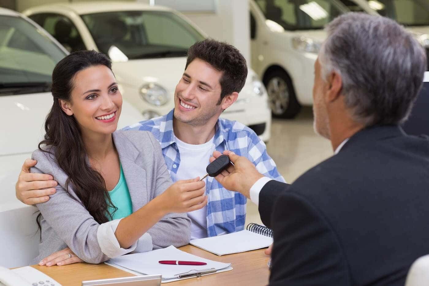 Couple smiling from their MINI vehicle purchase