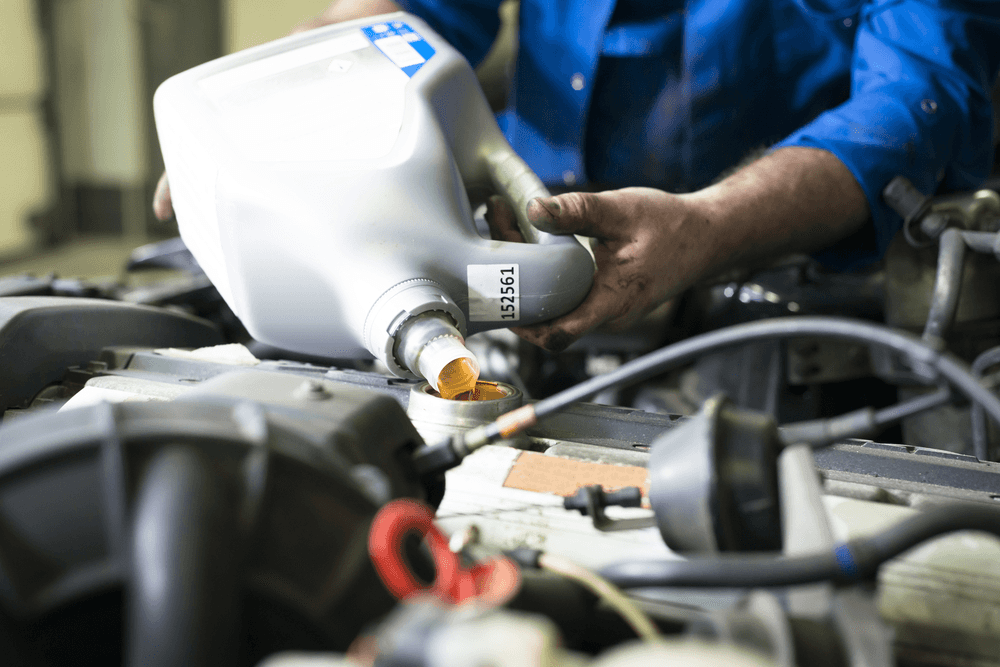 Technician Pouring Oil
