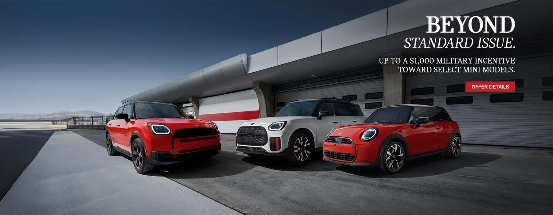 Three MINI's in front of a garage.