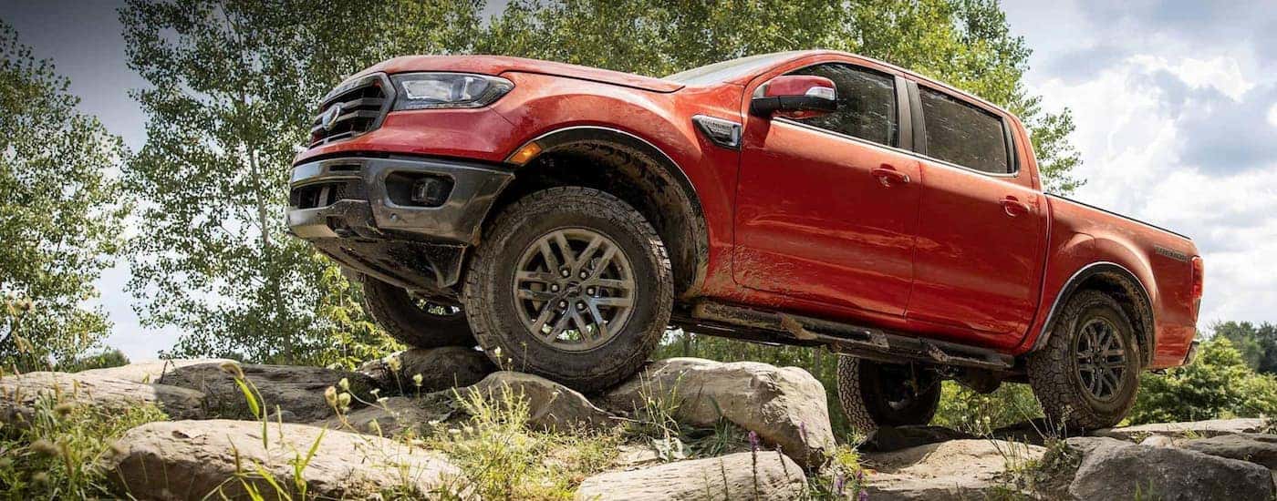 A red 2021 Ford Ranger Tremor is shown parked on a rock pile after leaving a Colorado Ford Ranger dealer.