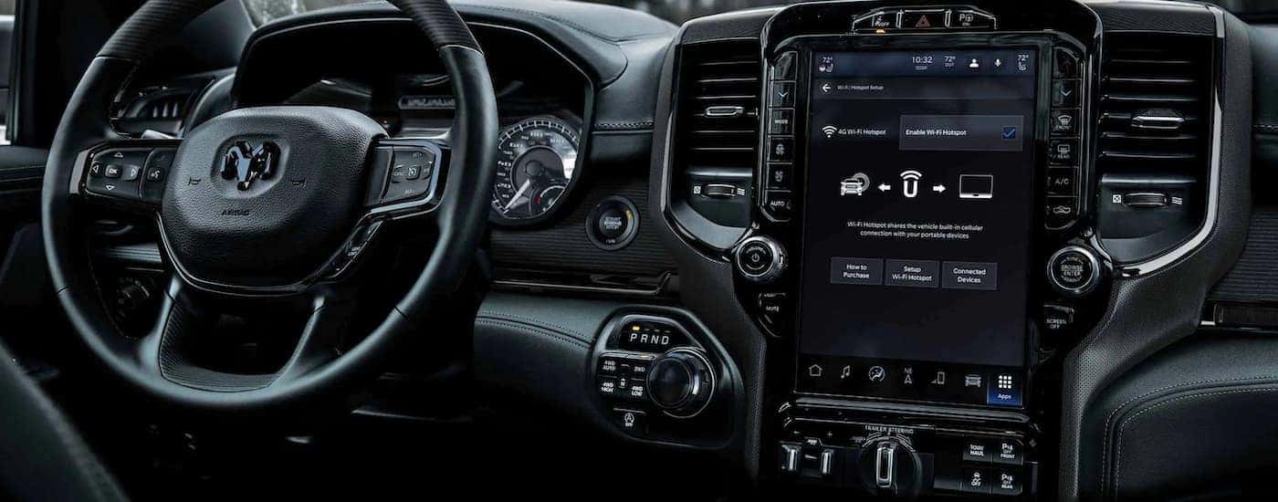 The steering wheel and infotainment screen with wifi is shown in a 2022 Ram 1500.