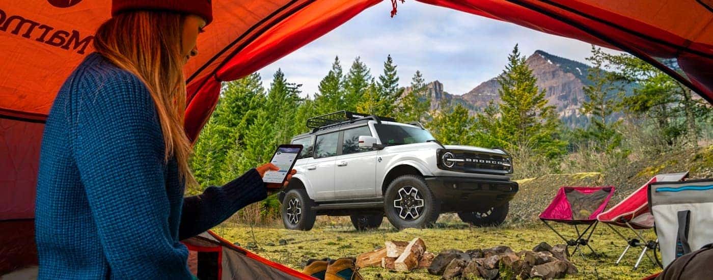 A silver 2021 Ford Bronco Outerbanks is shown parked outside of a tent after visiting a Colorado Ford Bronco dealership.