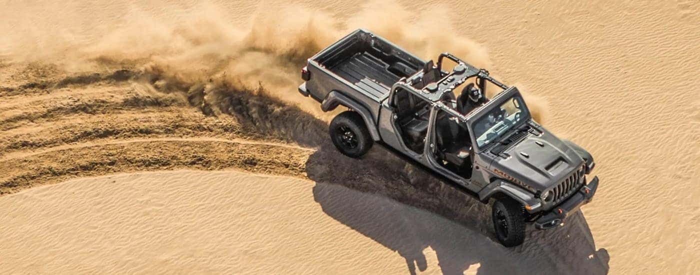 A silver 2022 Jeep Gladiator Mojave is shown from a high angle off-roading in a desert.