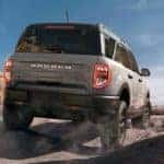 A grey 2022 Ford Bronco Sport Badlands is shown from the rear off-roading after leaving an Alamosa Ford dealership.