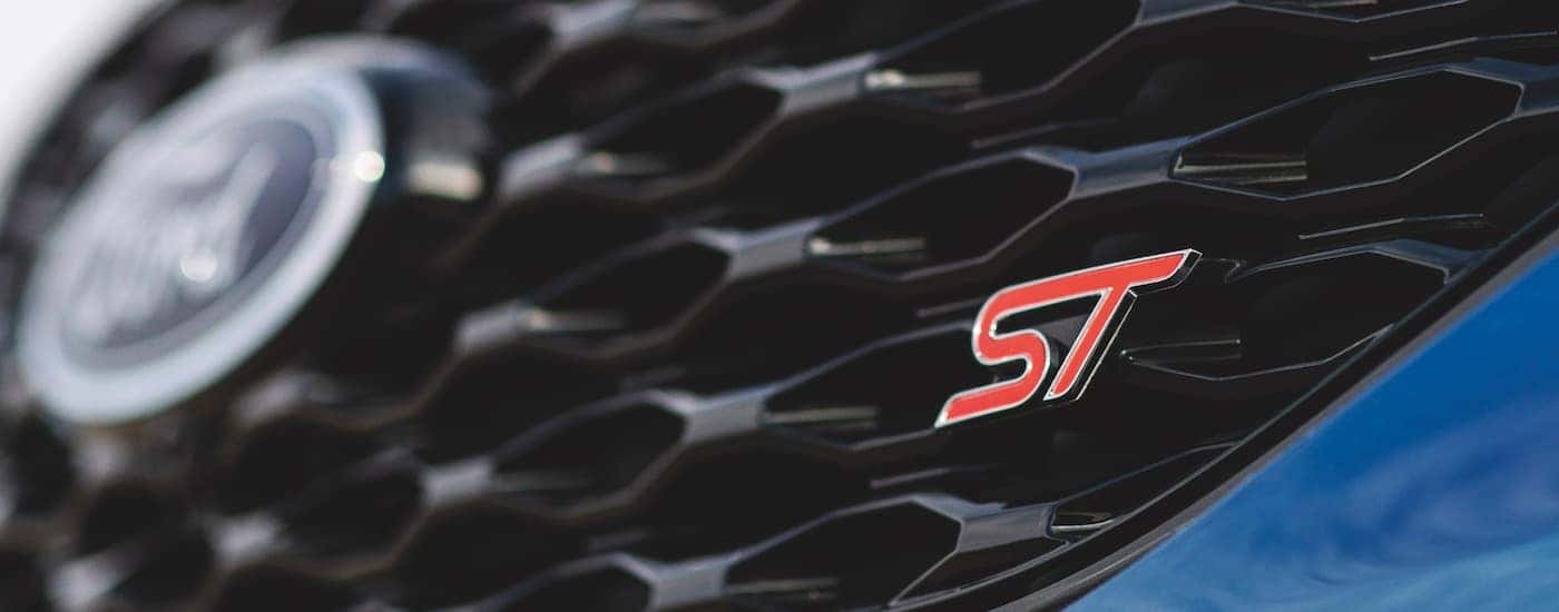 A close up shows the grill and ST badge on a blue 2022 Ford Explorer ST-Line.