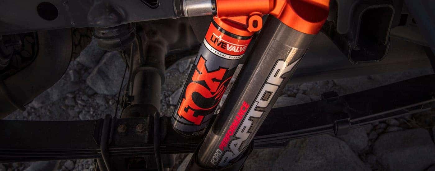 A close up shows Ford Performance and FOX Racing Shox on a 2021 Ford F-150 Raptor.