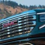 A close up shows the grille on a black 2023 GMC Sierra 1500 for sale.