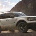 A white 2023 Ford Bronco Sport is shown from the side while off-road after leaving a dealer that has a Bronco Sport for sale near Buena Vista, CO.