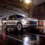 A silver 2023 Ford F-150 Lighting is shown from the front at an angle after leaving a truck dealer near Poncha Springs, CO.