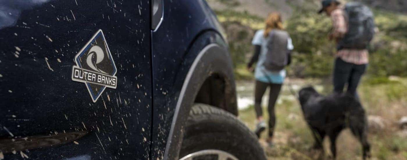 A close up shows the Outer Banks badge on a dark blue 2021 Ford Bronco Sport OuterBanks.
