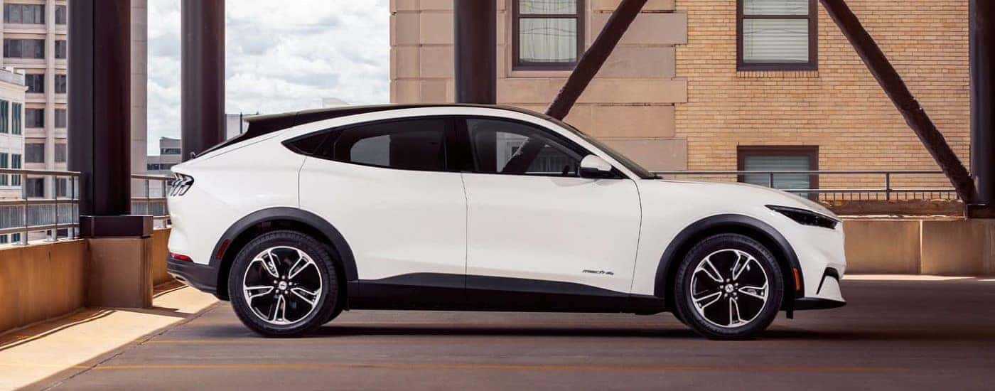 A white 2021 Ford Mustang Mach-E is shown from the side after getting electric car maintenance.