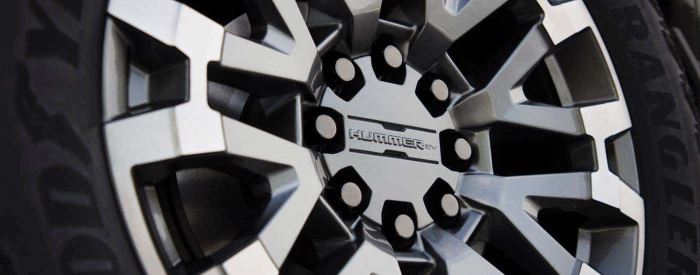 A close up shows a silver rim on a 2024 GMC Hummer EV.