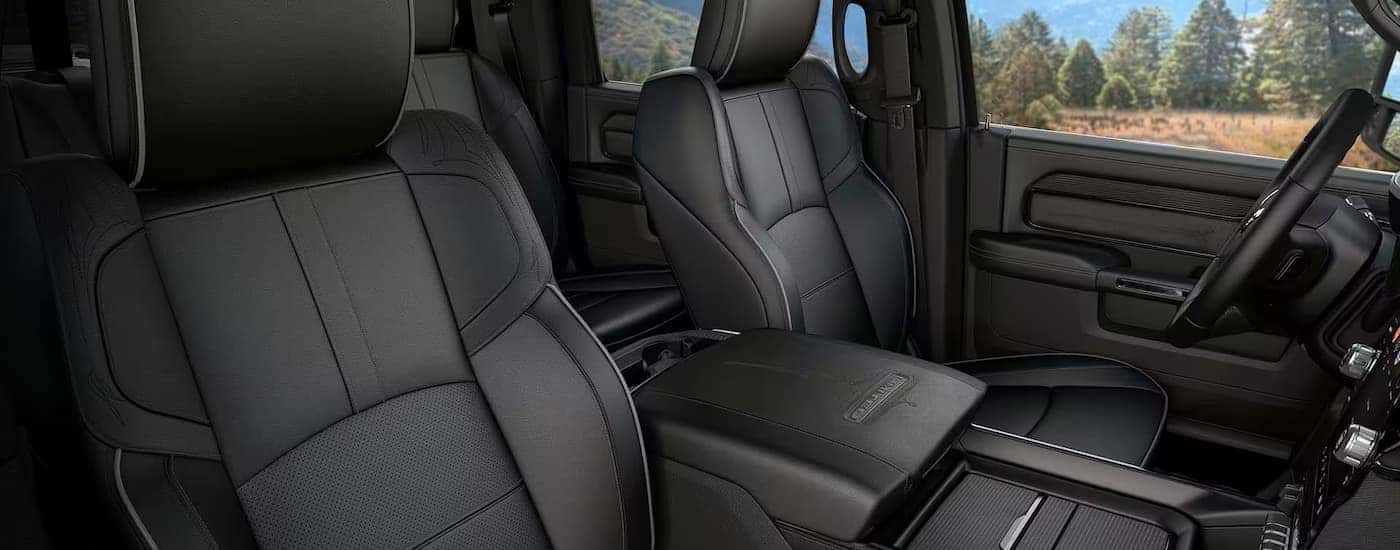 The black leather interior of a 2024 Ram 2500 is shown.