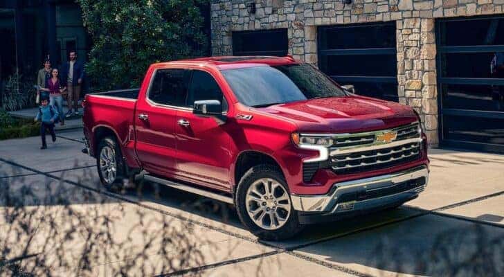 A popular truck for sale, a red 2023 Chevy Silverado 1500 Z71, is shown parked on a driveway.