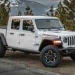A white 2024 Jeep Gladiator Rubicon parked off-road.