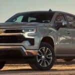 A silver 2024 Chevy Silverado 1500 Z71 is shown parked off-road.