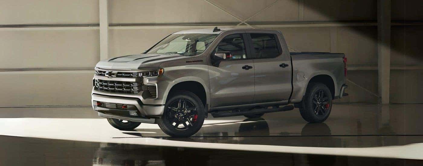 A grey 2024 Chevy Silverado 1500 Redline parked inside a building.