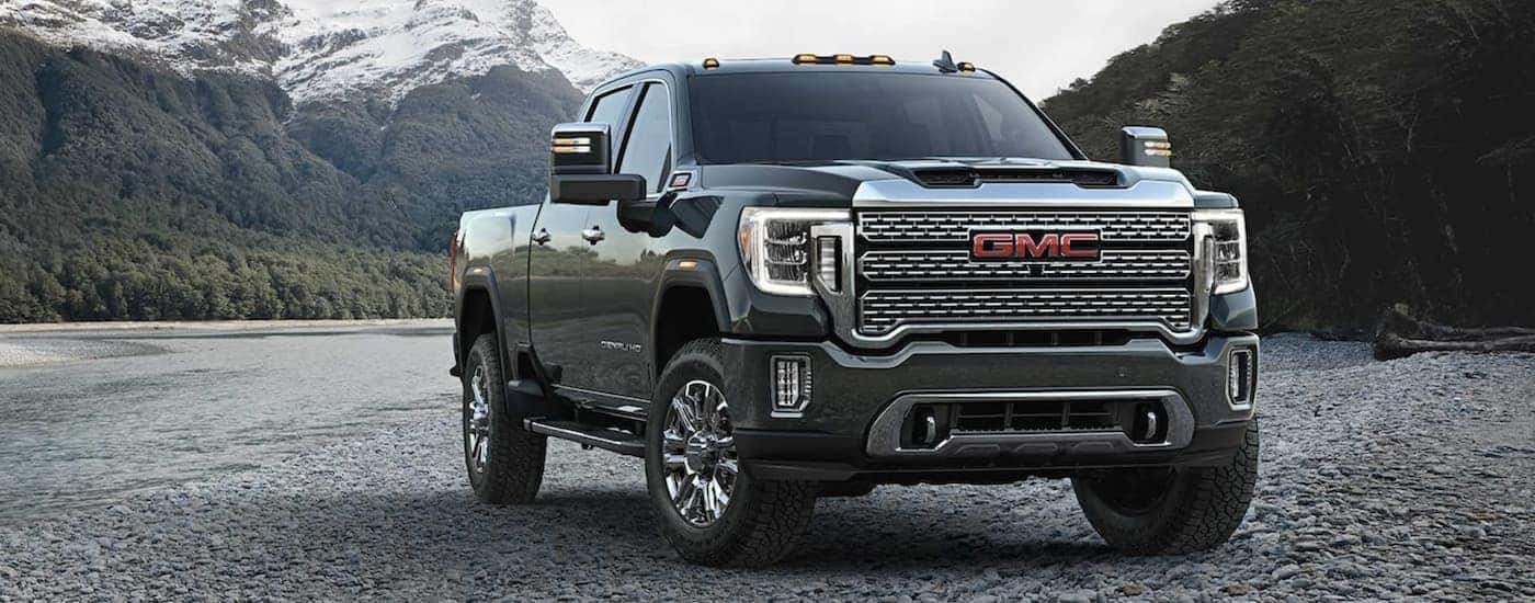 A black 2024 GMC Sierra 3500 HD parked off-road and angled right.