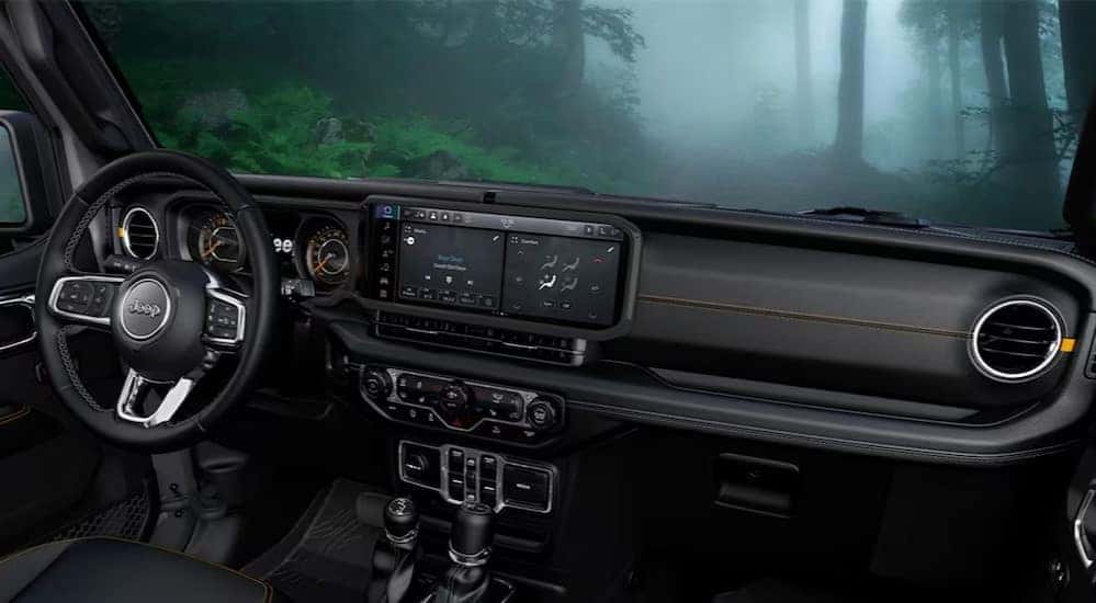 The black interior and dash are shown in a 2025 Jeep Wrangler.
