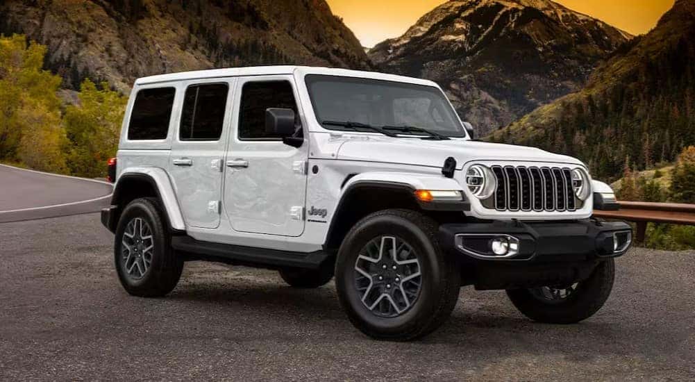 A white 2025 Jeep Wrangler is shown parked after visiting a Jeep dealer.