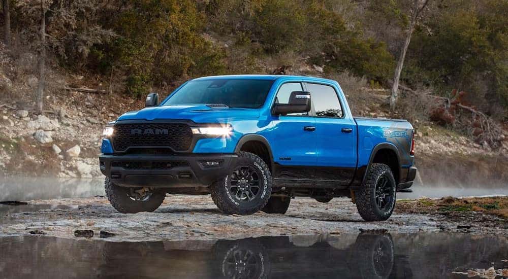 A blue 2025 Ram 1500 Rebel is shown from the front at an angle after leaving a Ram dealer.