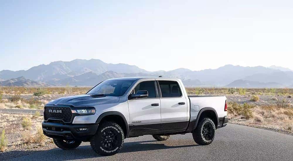 A silver 2025 Ram 1500 Rebel is shown from the side.