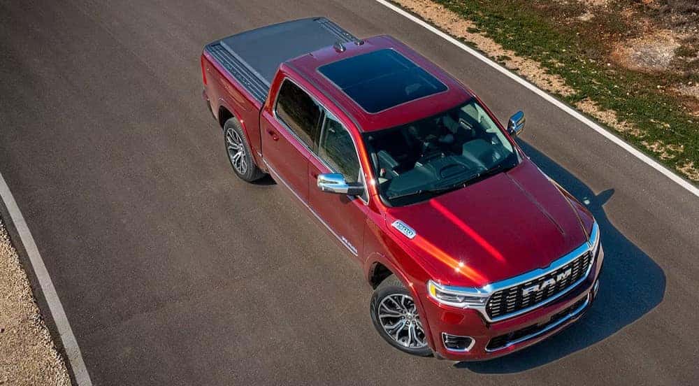 A red 2025 Ram 1500 is shown from an aerial view.