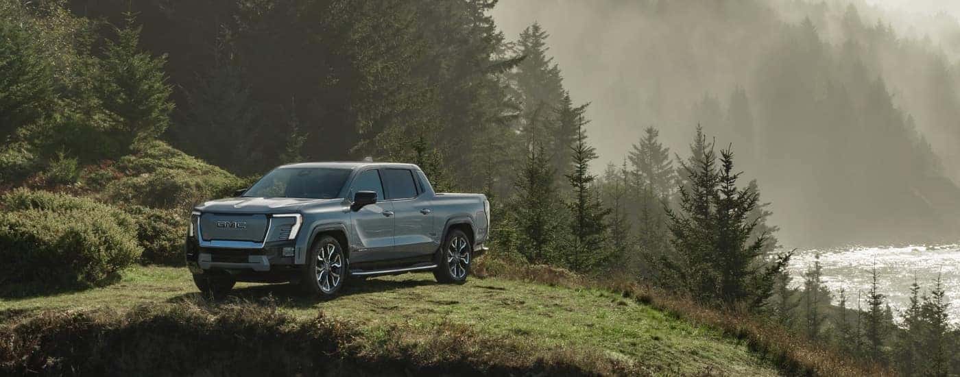 A blue 2025 GMC Sierra EV is shown from the front at an angle after leaving a GMC dealer.