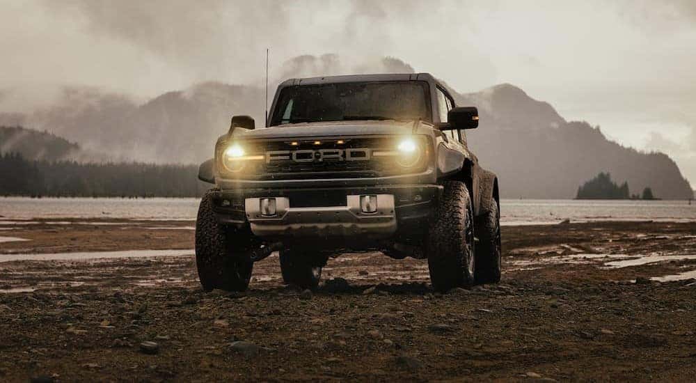 A gray 2025 Ford Bronco Raptor is shown parked off-road.