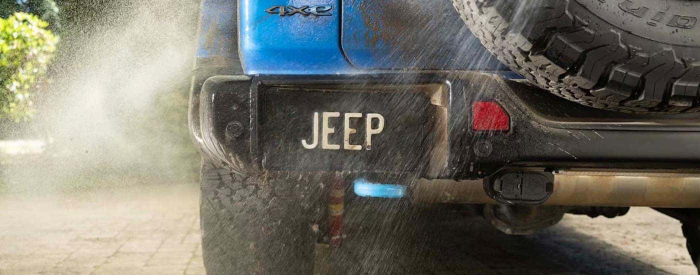 Blue 2025 Jeep Wrangler 4xe being cleaned.