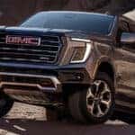 A dark gray 2025 GMC Yukon AT4 off-roading